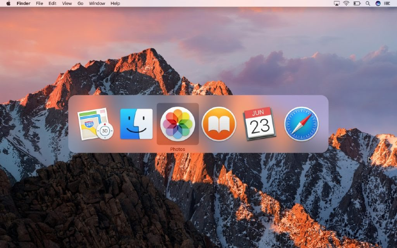 app switcher open on a clear macOS high sierra desktop background with the photos app highlighted app switcher open on a clear macOS high sierra desktop background with the photos app highlighted