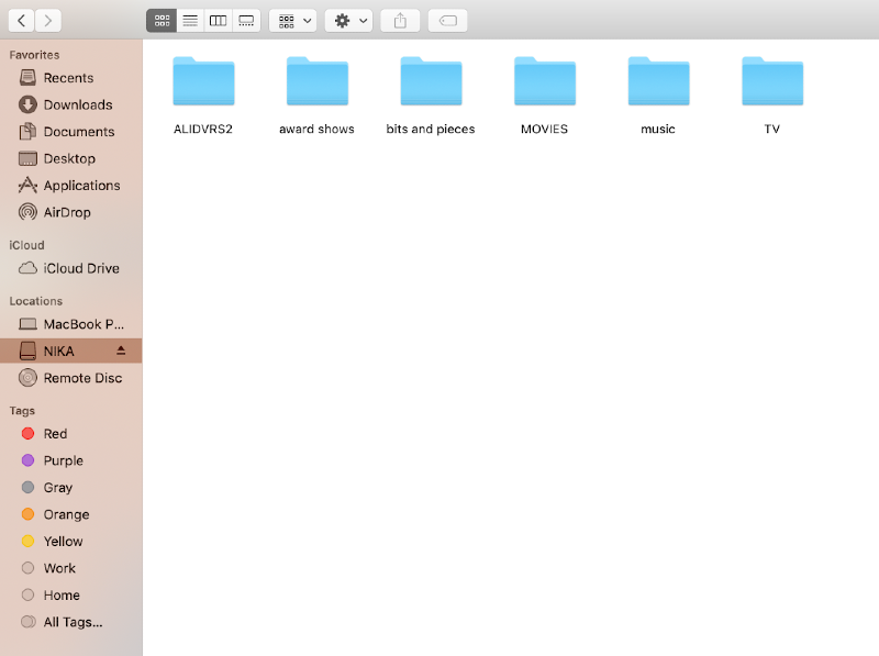 a finder window open on the external drive with the option to eject displayed next to the drive name a finder window open on the external drive with the option to eject displayed next to the drive name