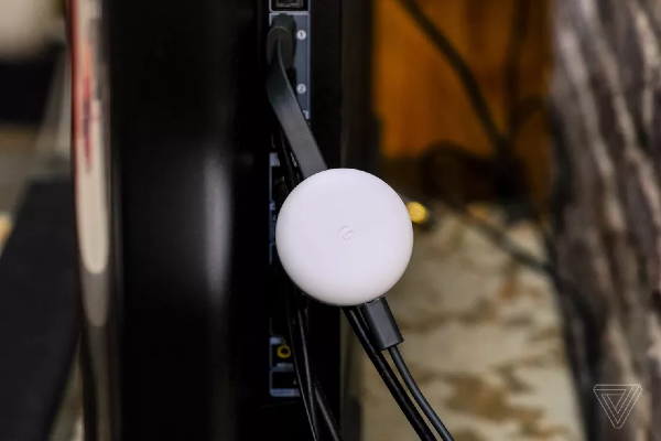 Chromecast device connected to a TV set with an HDMI connector Chromecast device connected to a TV set with an HDMI connector
